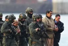 Nicolás Maduro escorted by armed officers in tactical gear.