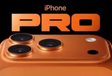 Close-up of an orange iPhone Pro with three camera lenses.