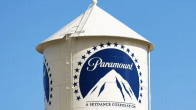 Paramount water tower with logo against a clear blue sky.