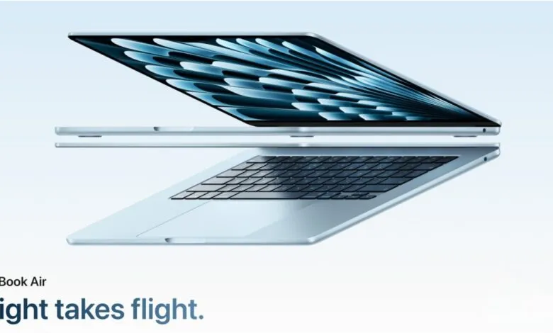 Sleek silver MacBook Air floating against a light blue gradient background.