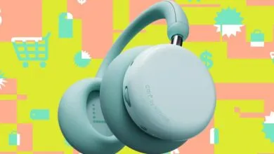 CMF by Nothing headphones in light blue against a colorful shopping-themed background.