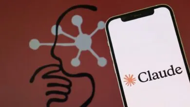 Smartphone displaying the Claude AI logo against a red background with a stylized brain graphic.