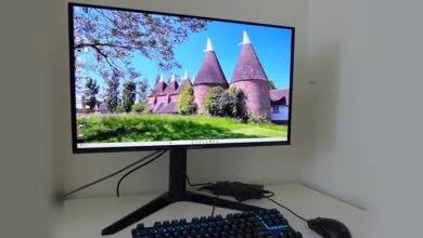 Predator monitor displaying a landscape with oast houses, keyboard, and mouse.