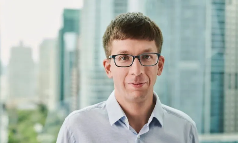 Headshot of Matei Zaharia, co-founder of Databricks, wearing glasses and a light blue shirt.