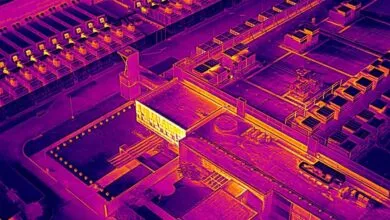 Aerial view of industrial complex in thermal imaging, showing heat signatures.