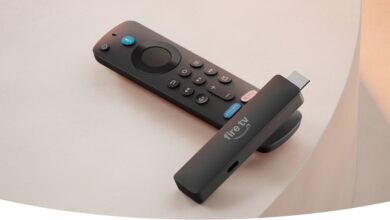 Amazon Fire TV Stick and remote on a light surface.