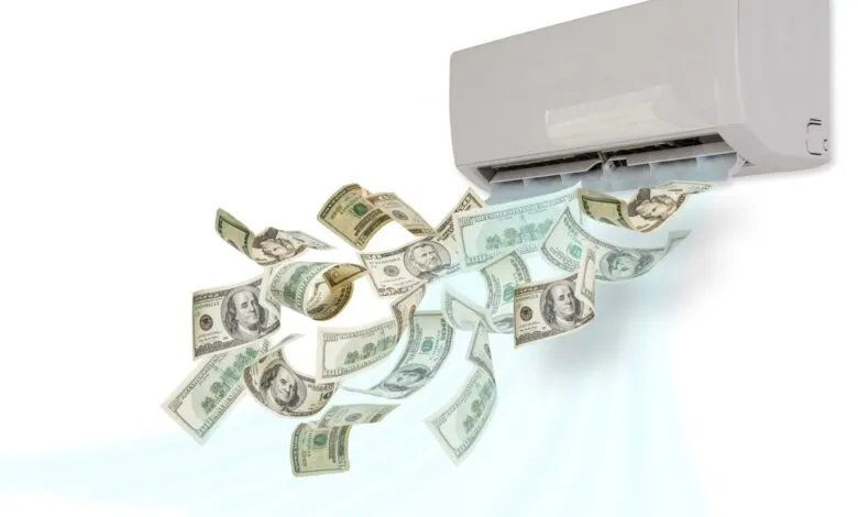 Air conditioner blowing out US dollar bills on a white background.