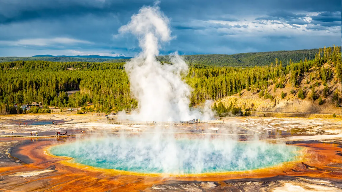 Grand Prismatic Spring in Yellowstone with colorful rings and rising steam.
