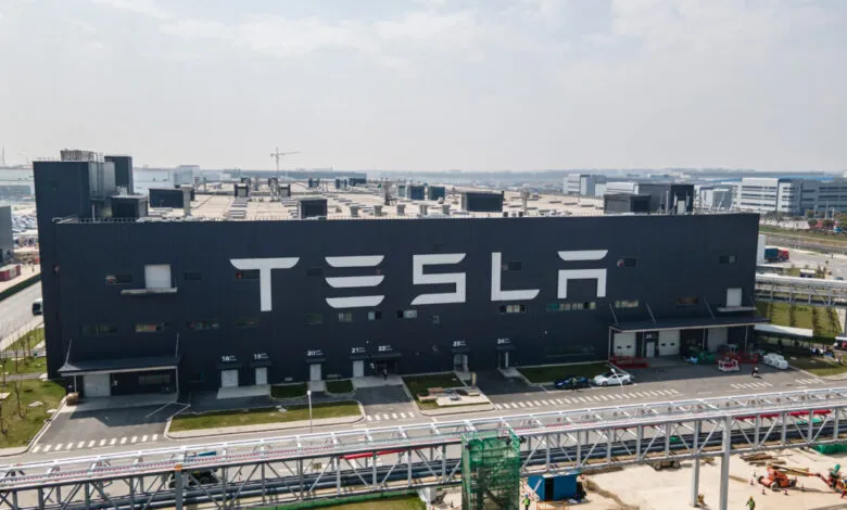 Aerial view of the Tesla Gigafactory Shanghai building with the Tesla logo.