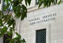 Exterior of the General Services Administration building with foliage.