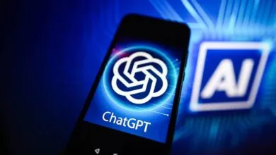 Smartphone displaying the ChatGPT logo against a blue AI background.