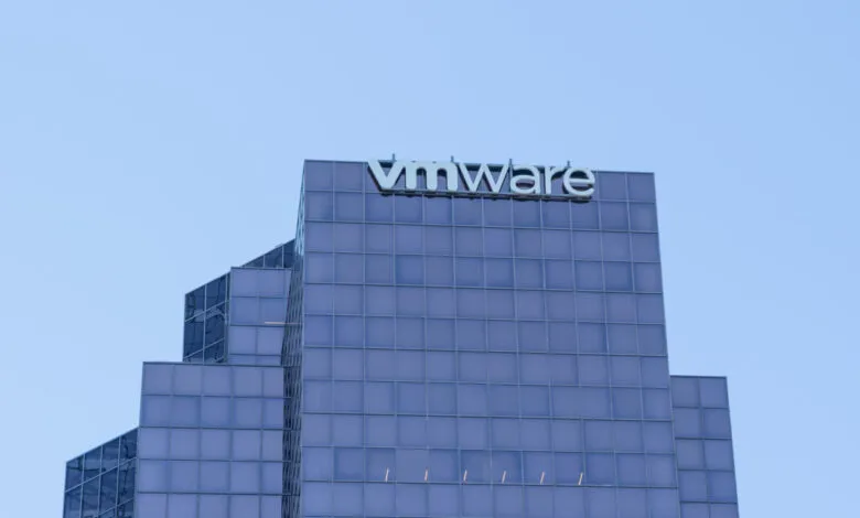VMware building exterior with glass facade and company logo against a blue sky.