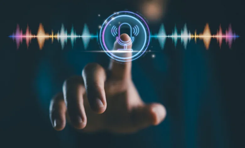 Finger touches glowing microphone icon on screen with sound waves.