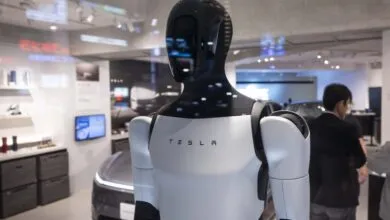 Tesla Optimus robot on display in a pop-up store, showcasing its humanoid form.