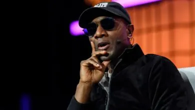 Raptors President Masai Ujiri speaks at event, wearing sunglasses.