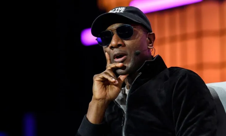 Raptors President Masai Ujiri speaks at event, wearing sunglasses.