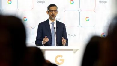 Sundar Pichai speaks at podium with Google logo backdrop.