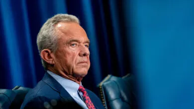 Portrait of Robert F. Kennedy Jr. in a suit and tie.