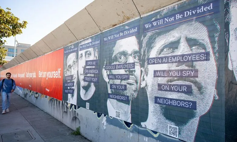 Mural showing AI surveillance protest with portraits of tech leaders.