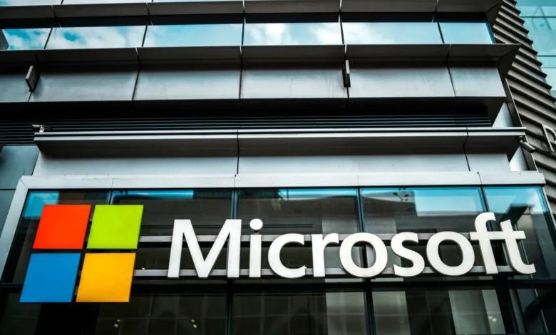 Microsoft logo on building exterior, featuring colorful squares and company name.