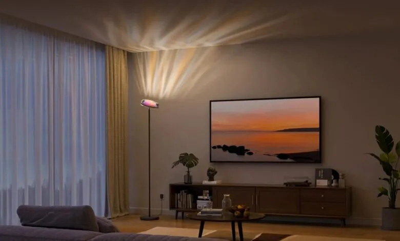 Modern living room with uplight floor lamp casting colorful light.