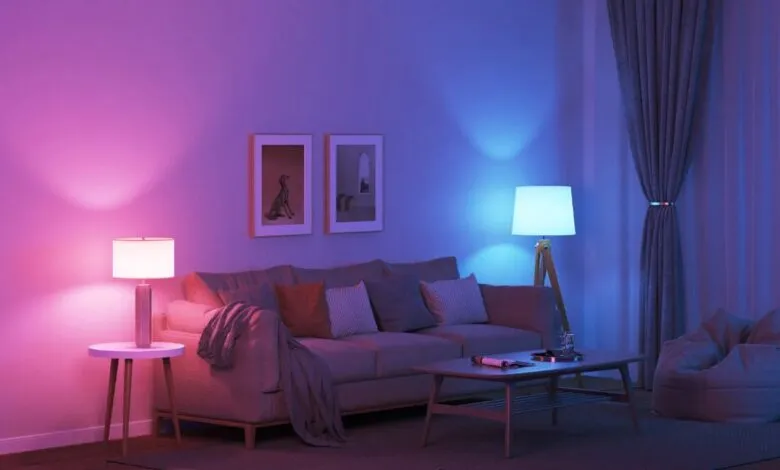 Living room with smart LED bulbs emitting pink and blue light.