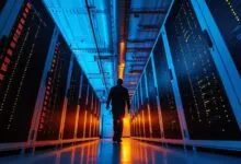 Person walks down a server room aisle, surrounded by glowing servers.