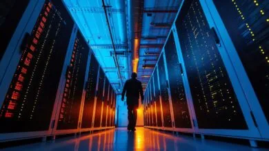 Person walks down a server room aisle, surrounded by glowing servers.