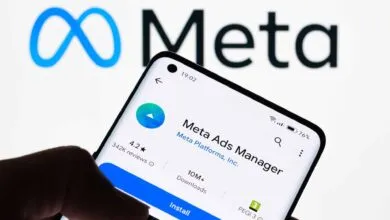 Meta Ads Manager app on phone with Meta logo in background.