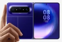 Foldable purple smartphone with advanced camera system being held by a hand.