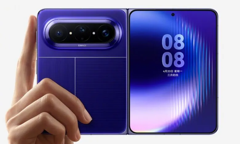 Foldable purple smartphone with advanced camera system being held by a hand.