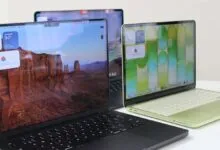 Three Apple MacBooks on a white surface, each with a different screen display.