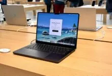 Apple MacBook Pro 14-inch on display in a retail store setting.