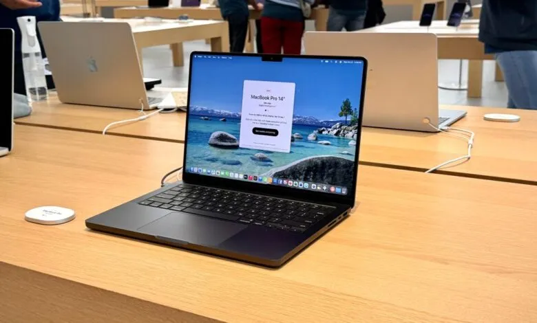 Apple MacBook Pro 14-inch on display in a retail store setting.