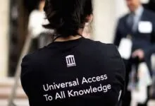 Person wearing Internet Archive shirt with 'Universal Access To All Knowledge'.