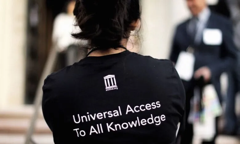 Person wearing Internet Archive shirt with 'Universal Access To All Knowledge'.