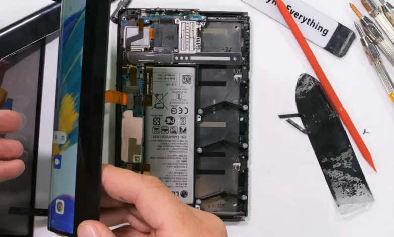 LG rollable phone being disassembled, internal components visible.