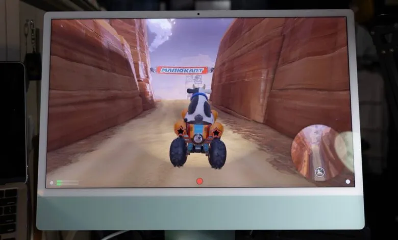 iMac displaying a Mario Kart race with a cow character driving through a canyon.