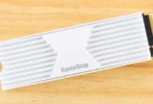 GameStop branded NVMe SSD with white heatsink on wood surface.
