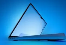 Sleek laptop with screen slightly open against a blue gradient background.