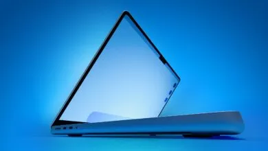 Sleek laptop with screen slightly open against a blue gradient background.