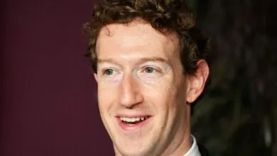 Close-up of Mark Zuckerberg smiling slightly at an event.
