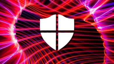White shield icon against a vibrant, abstract background of red and purple light trails.