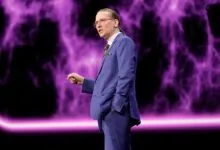 Mikko Hypponen presents on stage with purple nebula backdrop.