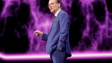 Mikko Hypponen presents on stage with purple nebula backdrop.
