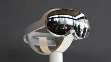 Close-up of a white VR headset with mirrored lenses on a display stand.