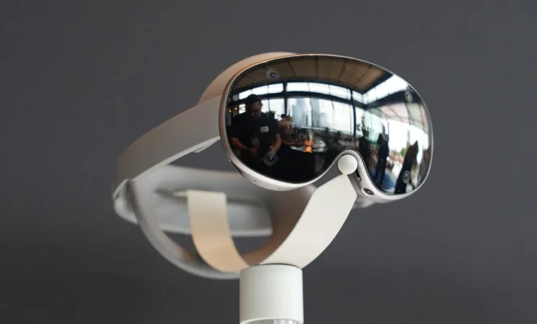 Close-up of a white VR headset with mirrored lenses on a display stand.