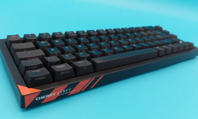 Black Cherry XTRFY K5 Pro TMR Compact keyboard on a blue background.