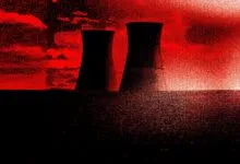 Two cooling towers silhouetted against a red sky, ominous mood.