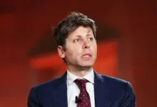 Man in suit looks up with a thoughtful expression.